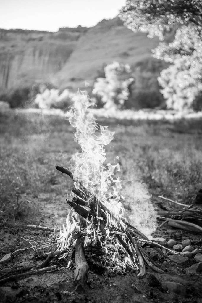 A campfire at dusk inside Canyon de Chelly